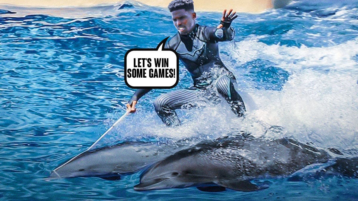Tyreek Hill riding on the backs of two Dolphins proclaiming that it's time to win some games