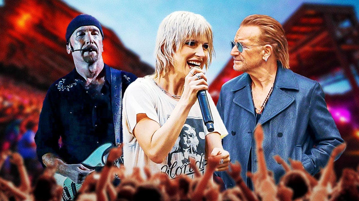 U2 guitarist the Edge and singer Bono with Paramore lead singer Hayley Williams in front of them and the Red Rocks Ampitheatre behind them.