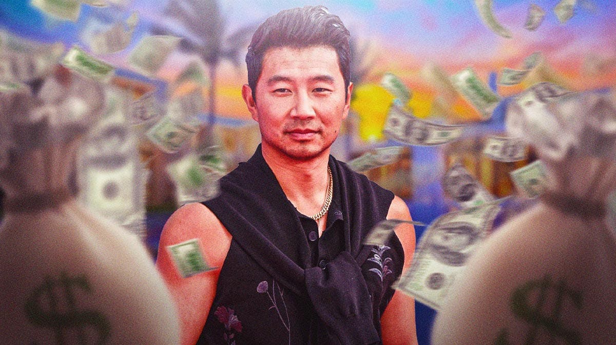 Simu Liu surrounded by piles of cash.