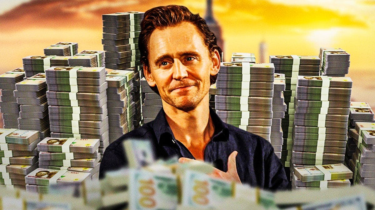 Tom Hiddleston surrounded by piles of cash.