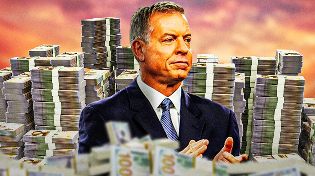 Troy Aikman surrounded by piles of cash.