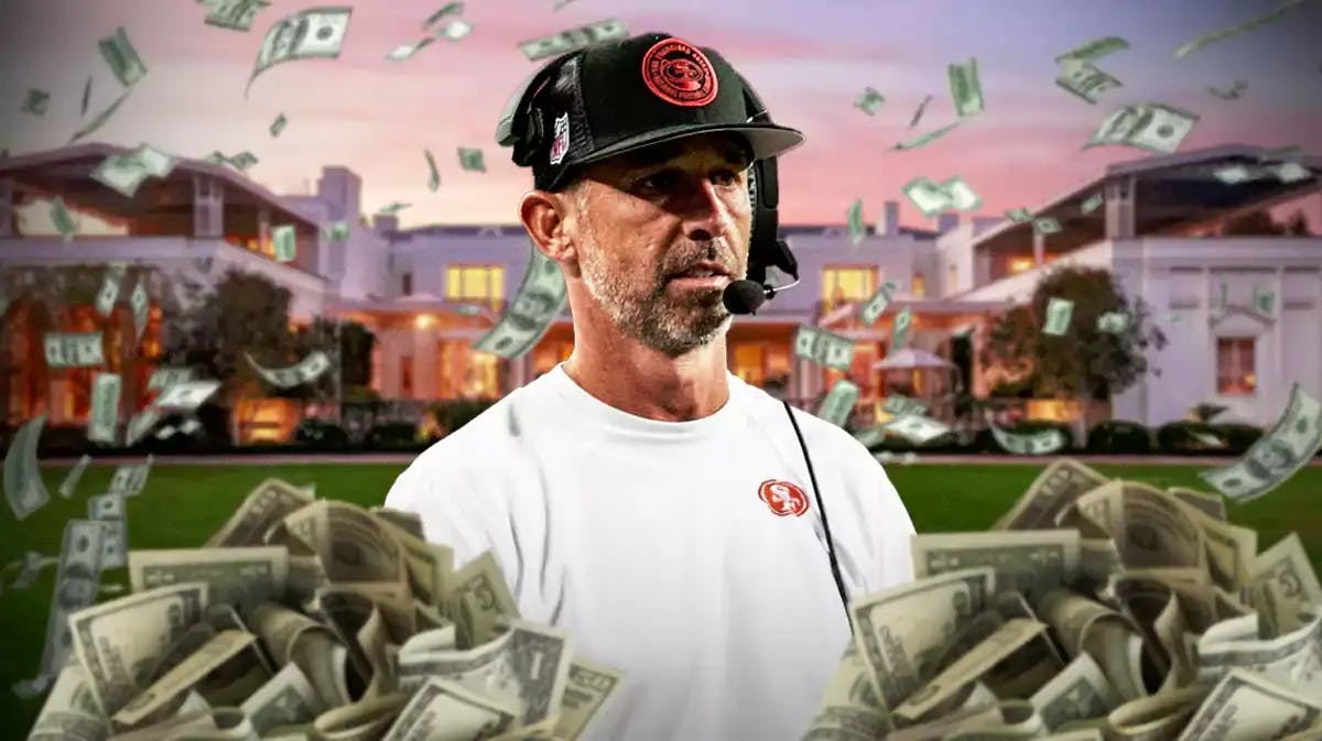Kyle Shanahan surrounded by piles of cash.