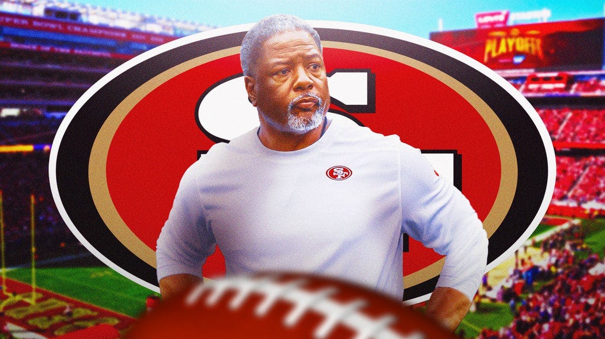 Steve Wilks looking disappointed with the 49ers logo in the background