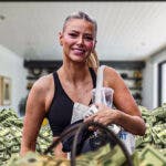 Ariana Madix surrounded by piles of cash.