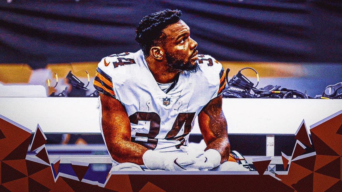 Browns' Jerome Ford looking serious sitting down on an NFL sideline.