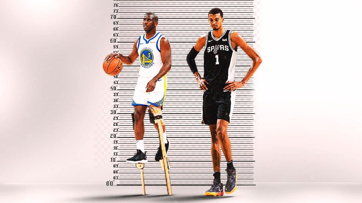 Warriors' Chris Paul (6'0 height) with wooden sticks on his legs so that he could be the same height as Spurs' Victor Wembanyama (7’4), with a height chart behind them