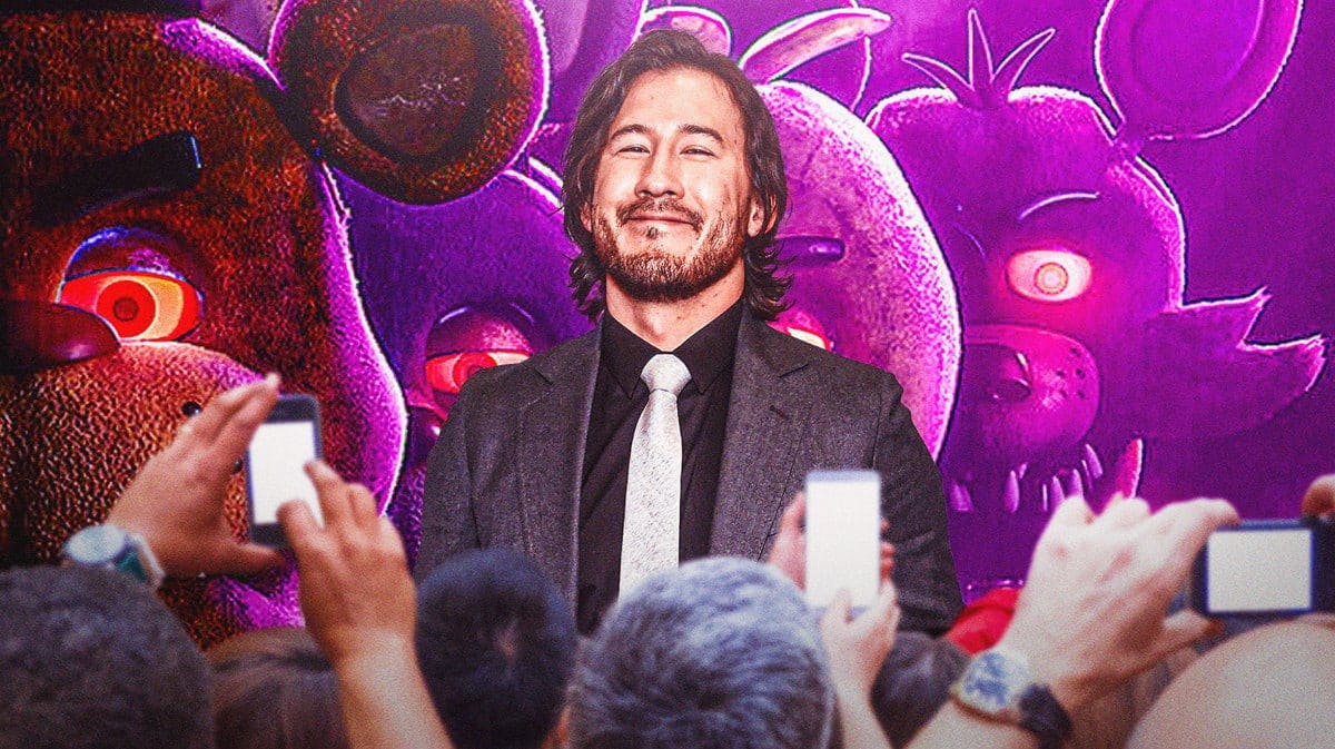 Markiplier in front of Five Nights at Freddy's movie poster.