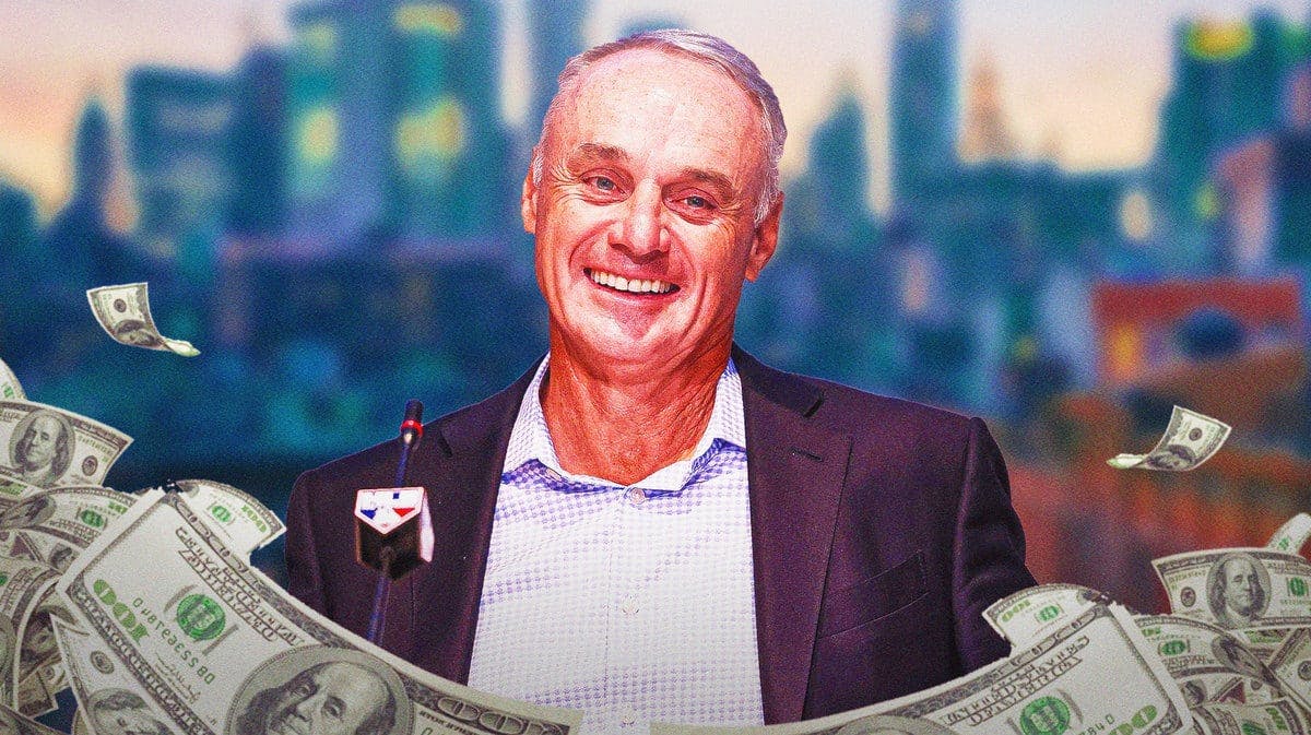 MLB commissioner Rob Manfred surrounded by piles of cash.