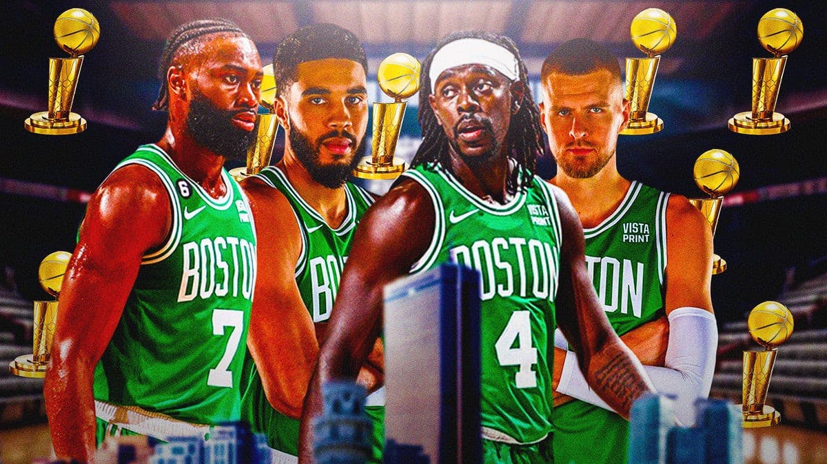 Jaylen Brown, Jayson Tatum, Jrue Holiday, and Kristaps Porzingis all looking serious and surrounding an NBA Finals trophy