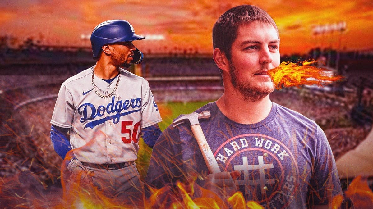 Dodgers' Mookie Betts in background. Trevor Bauer (normal clothes) breathing fire in front.