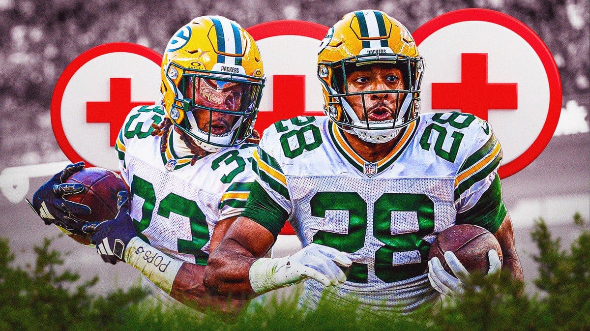 Green Bay Packers Aaron Jones and AJ Dillon with medical crosses around them