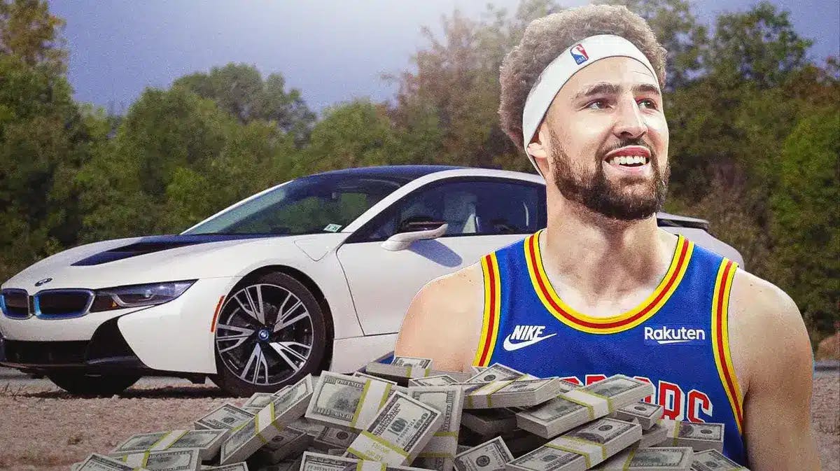 The Golden State Warriors' Klay Thompson in front of a car from his collection.