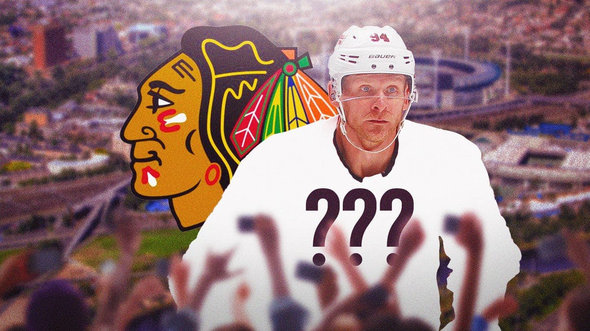 Corey Perry with a blank jersey next to the Blackhawks logo