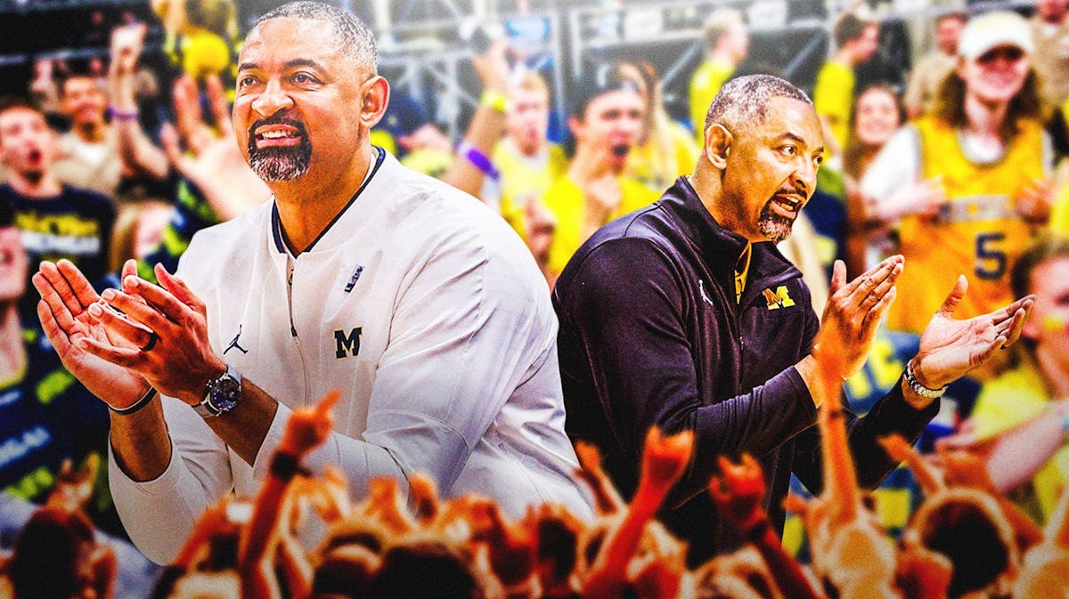 Michigan basketball coach Juwan Howard on the left, and right of foreground. Michigan fans cheering in the background.