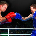 Mark Zuckerberg and Elon Musk in a boxing ring with fists up