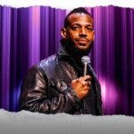 Marlon Wayans on a stage with a mic.