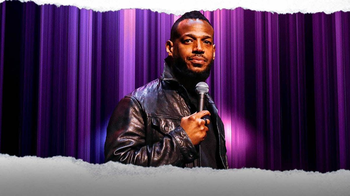 Marlon Wayans on a stage with a mic.
