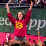Viral clip of Olivia Rodrigo flashing the "fight on" signal and celebrating on the sideline in a USC band sweatshirt