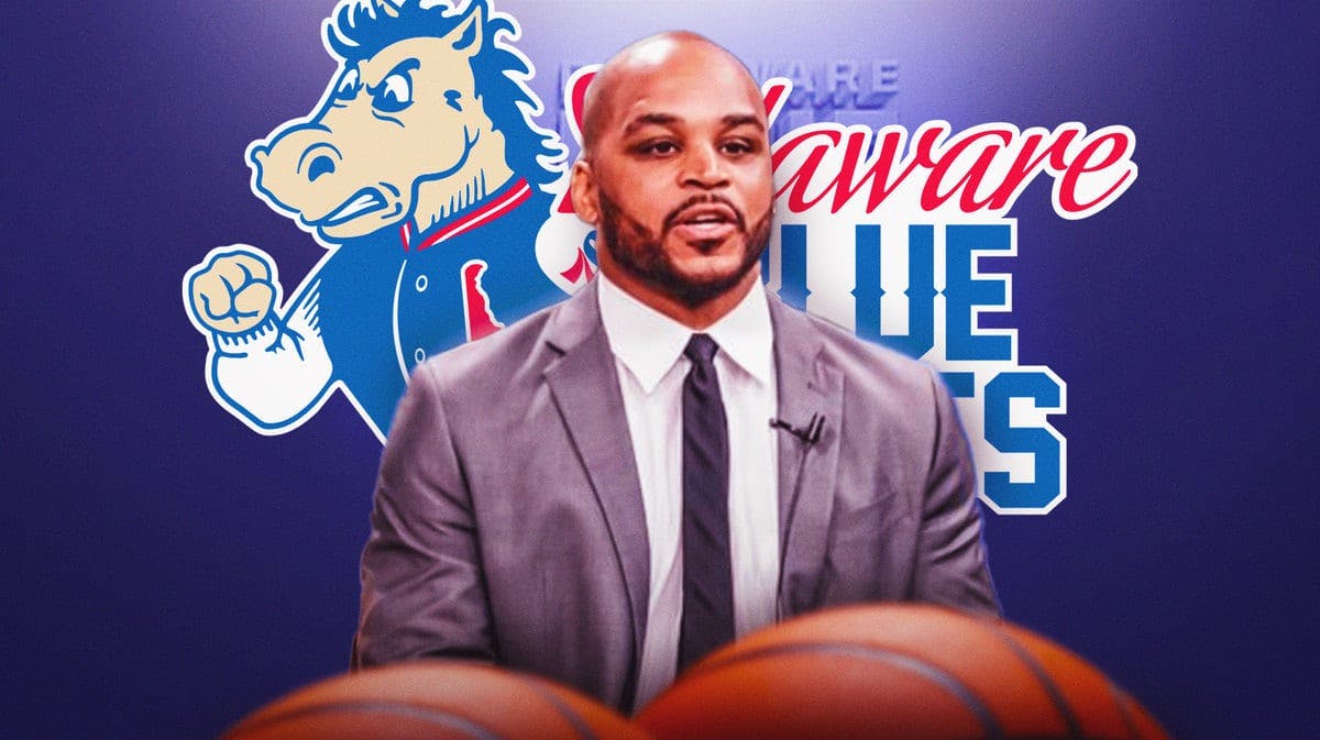 Jameer Nelson in front of the logo of the Blue Coats, the Sixers' G League affiliate