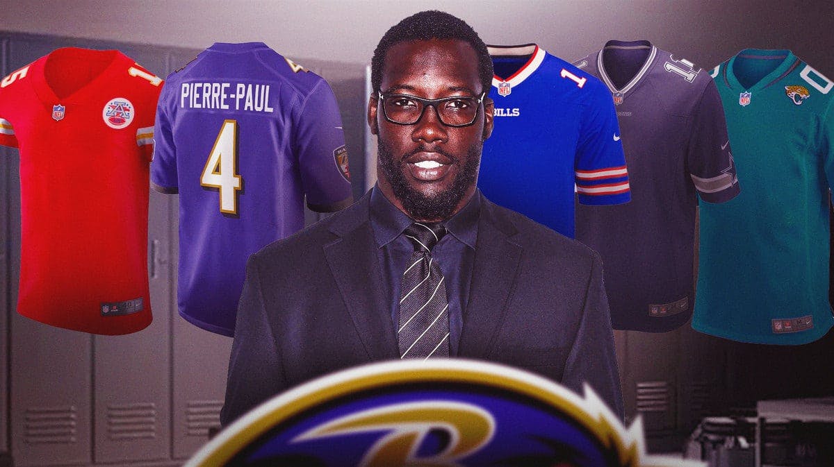 Jason Pierre-Paul in a suit in a locker room with a bunch of different jerseys around him