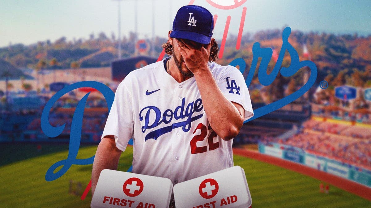 Clayton Kershaw in middle of image looking stern, first aid kit, LA Dodgers logo, baseball field in background