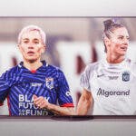 Megan Rapinoe in her OL Reign uniform and Ali Krieger in her Gotham FC uniform, inside of a television in the NWSL Finals
