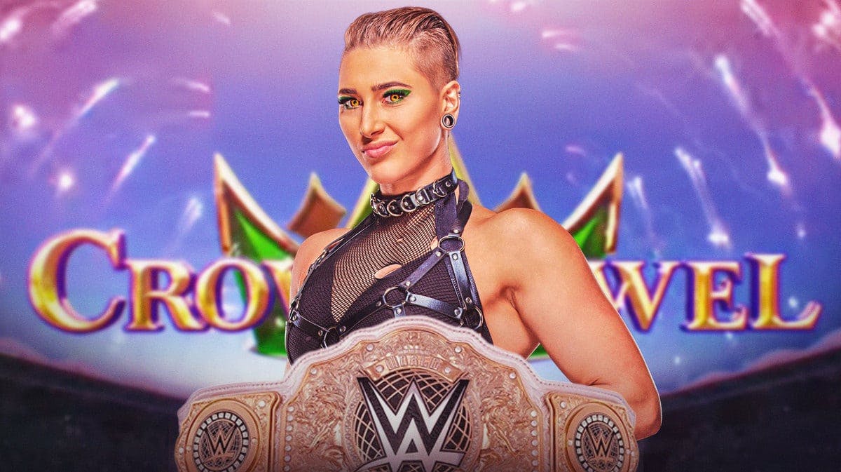 Rhea Ripley with the WWE Women’s World Championship in front of the Crown Jewel logo.