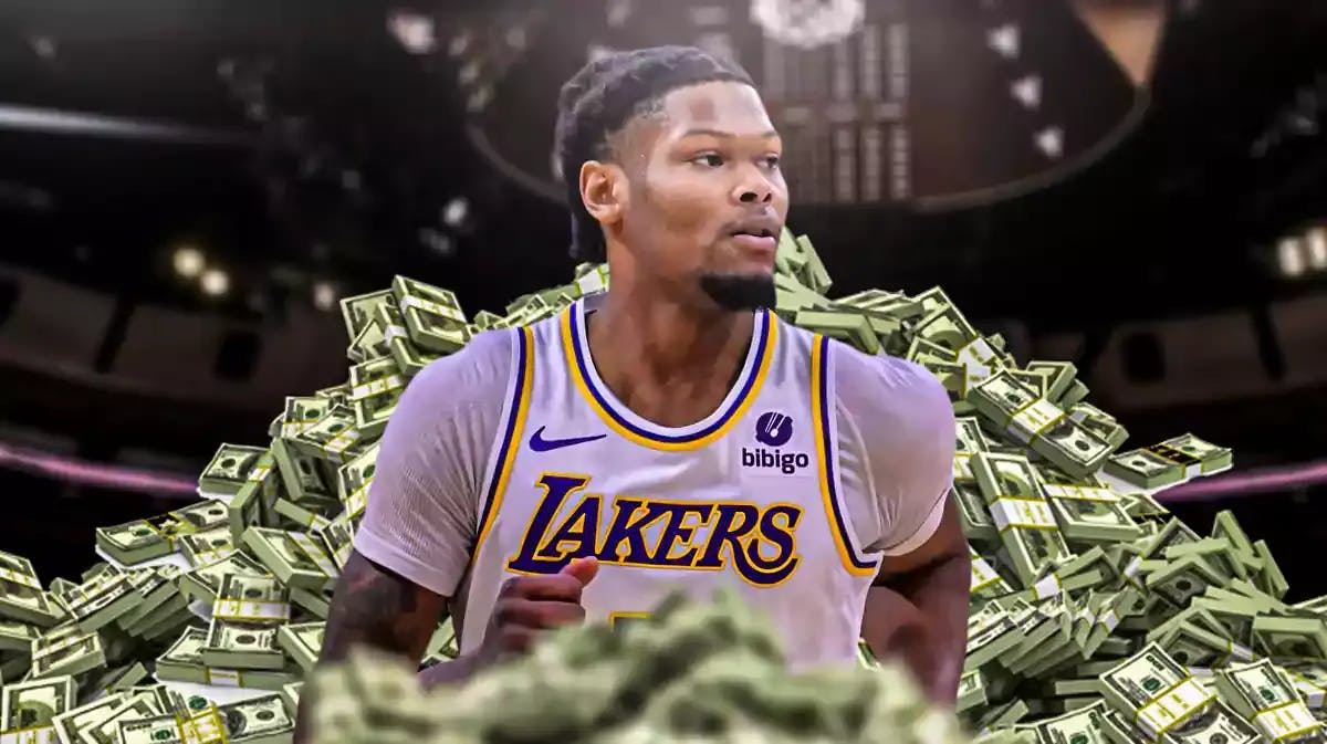 Cam Reddish surrounded by piles of cash.