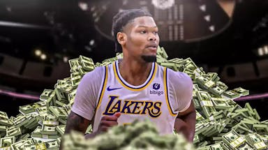 Cam Reddish surrounded by piles of cash.