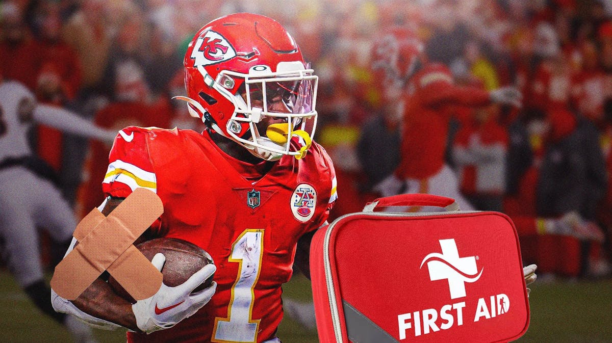 Kansas City Chiefs running back Jerick McKinnon in the foreground with a first aid bag next to him.