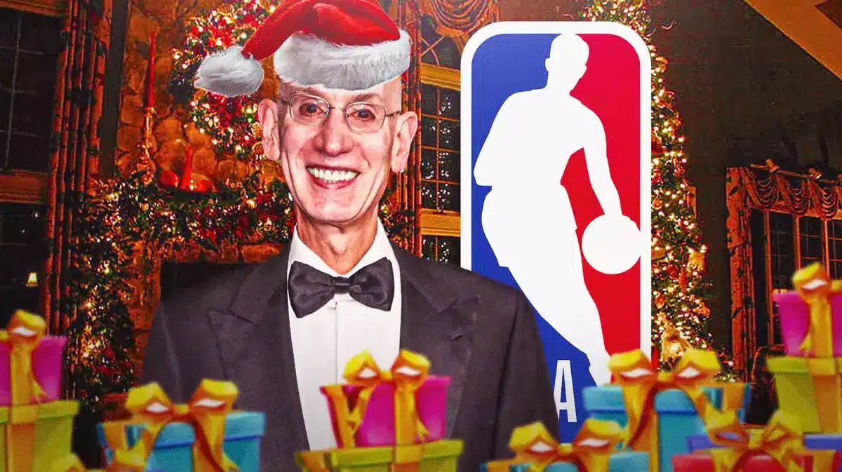 Adam Silver with Santa Claus hat on. Snow/presents/Christmas trees in the background. NBA logo in the middle front.