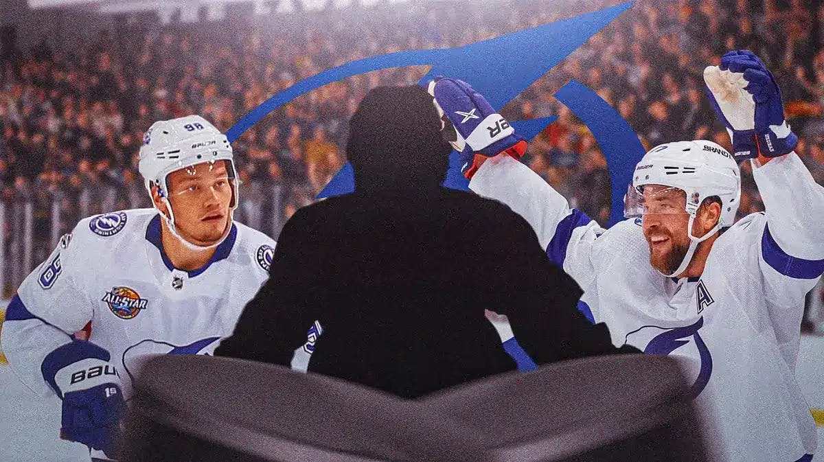 Victor Hedman and Mikhail Sergachev on either side of image looking hopeful, silhouetted Tampa Bay Lightning player in middle of image, TB Lightning logo, hockey rink in background