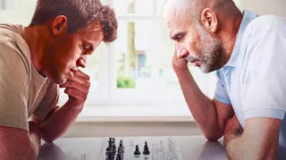 Pep Guardiola and Magnus Carlsen playing chess against each other manchester city