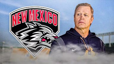 Head coach Bronco Mendenhall next to the New Mexico football logo in front of University Stadium.