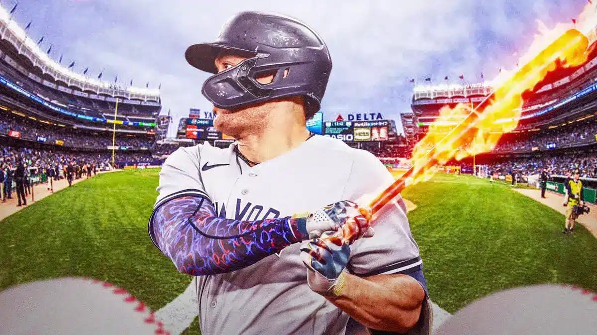 Yankees' Giancarlo Stanton swinging a bat with fire coming off the bat at Yankee Stadium