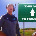 Tulane coach Willie Fritz looking at a sign saying "This Way to Houston."