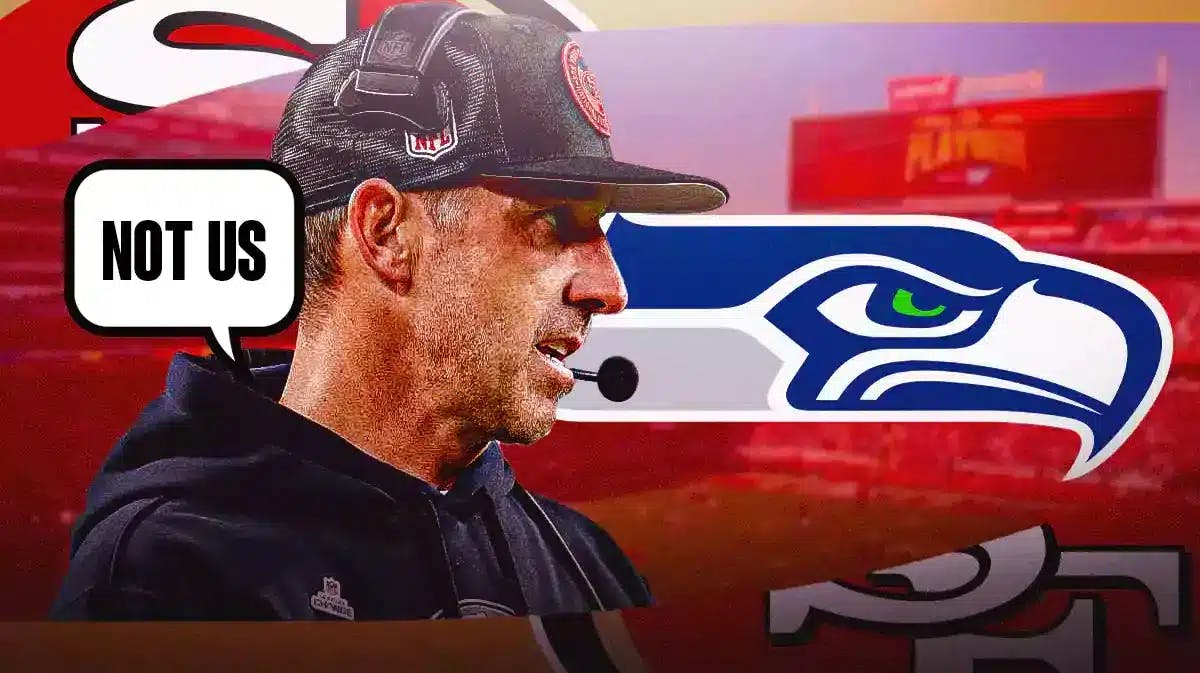 SF 49ers coach Kyle Shanahan looking annoyed and speech bubble “Not Us” and logo of Seattle Seahawks he is looking at/talking to.