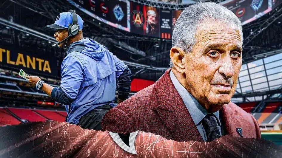 Former Rams DC Raheem Morris stands next to Arthur Blank after beating Bill Belichick for the coaching job
