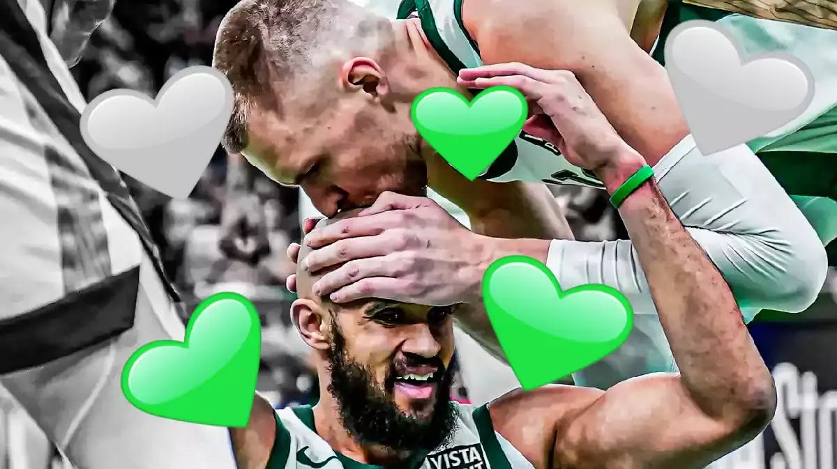 Kristaps Porzingis giving his Boston Celtics teammate, Derrick White, a kiss on the head