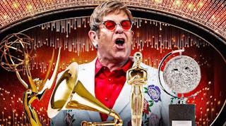 Elton John with EGOT trophies (Emmy Award, Grammy, Oscar Academy Award, and Tony Award).