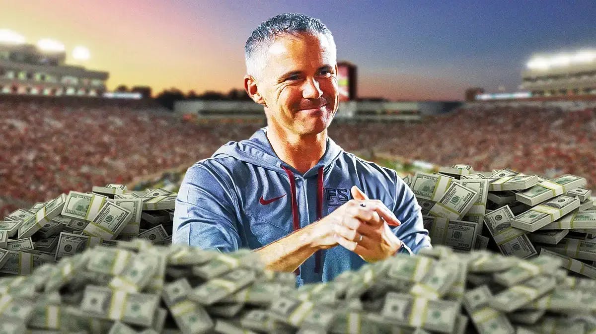 Image: Florida State coach Mike Norvell smiling with lots of money swirling around him