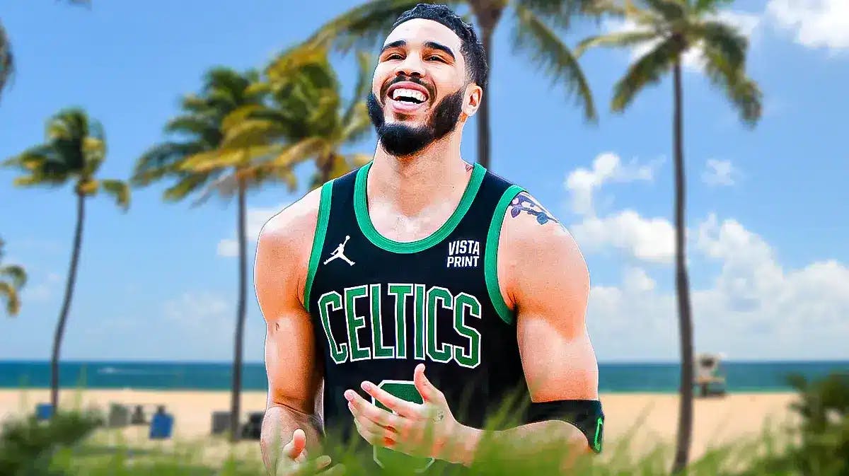 Jayson Tatum looking happy on a Miami beach background.