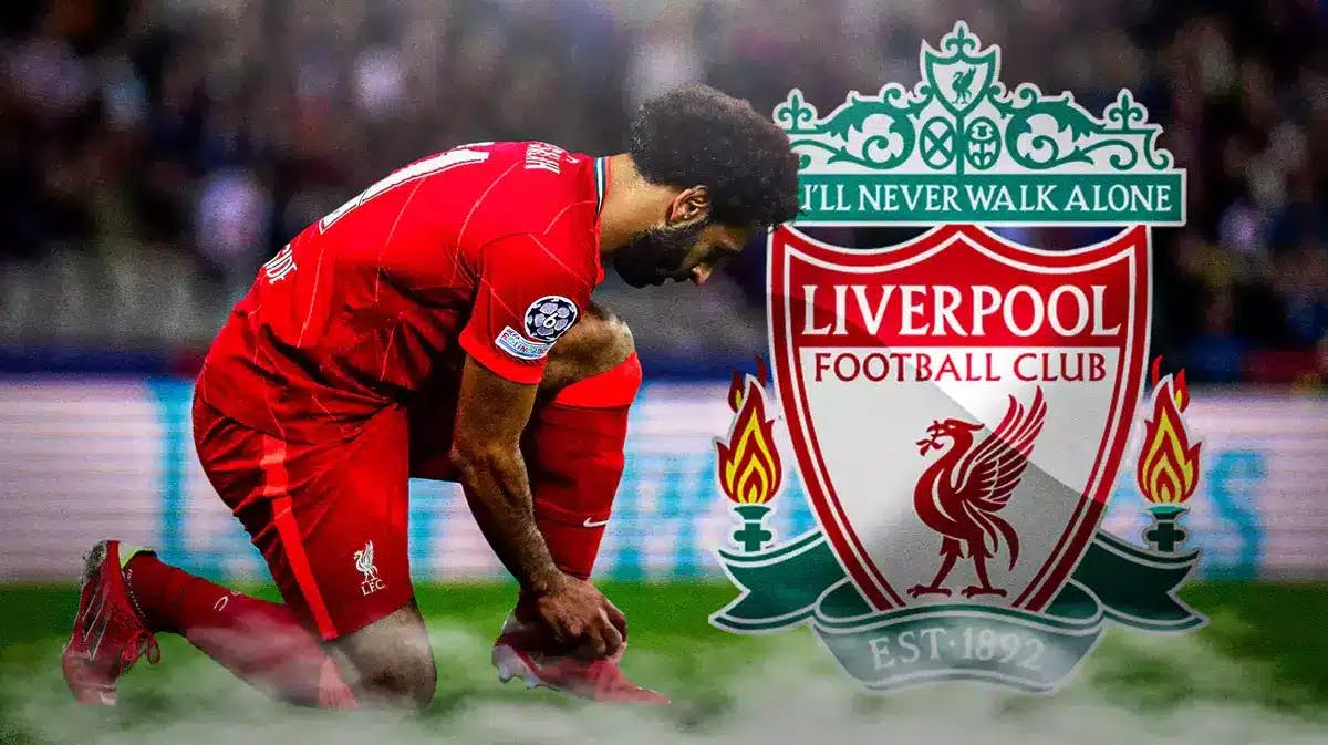 Mohamed Salah tying his boots preferably, in front of the Liverpool logo