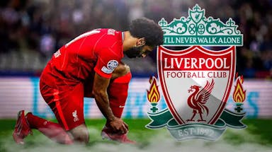 Mohamed Salah tying his boots preferably, in front of the Liverpool logo