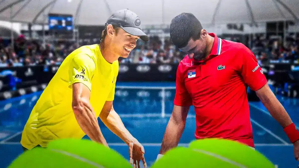 Photo: Novak Djokovic grimacing in pain, Alex De Minaur beside him in action smiling