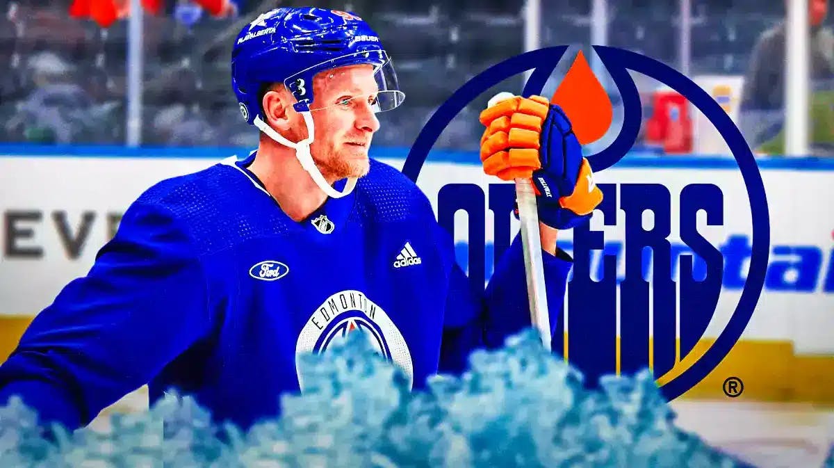 Corey Perry in middle of image in an Edmonton Oilers jersey looking happy, EDM Oilers logo, hockey rink in background