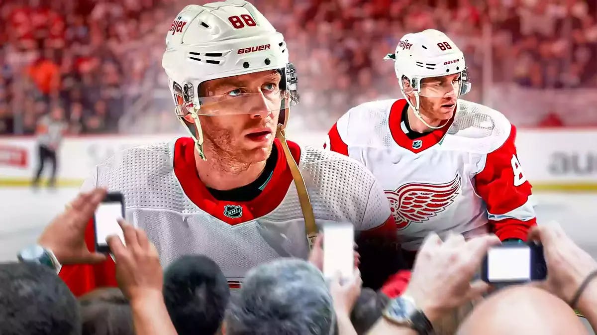 Red Wings' Patrick Kane in front looking serious. Red Wings' Patrick Kane in background playing hockey.