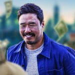 Randall Park surrounded by piles of cash.