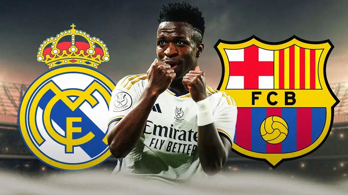 Vinicius Jr. laughing inbetween the Real Madrid and Barcelona logos