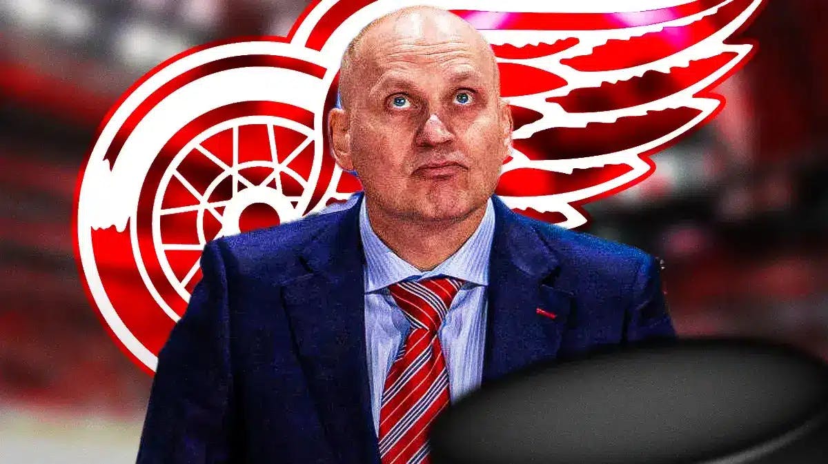 Red Wings coach Derek Lalonde with the Red Wings logo behind him. Please use an image of the Red Wings home rink as the background image.